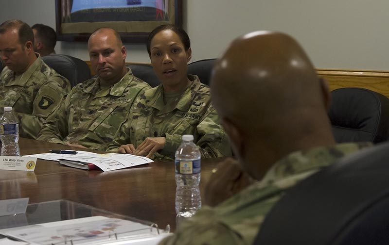 Soldier responding to her superior during a meeting