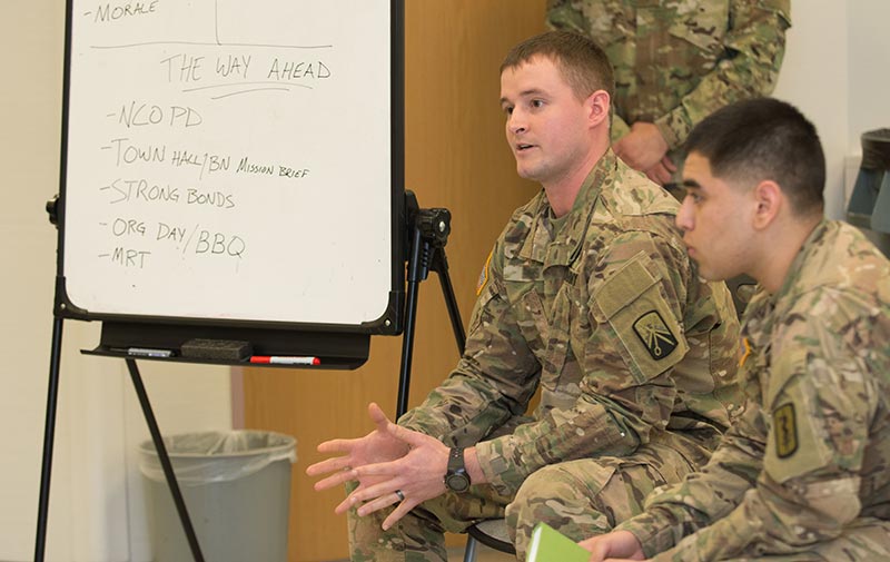 Soldier discussing ideas at a training