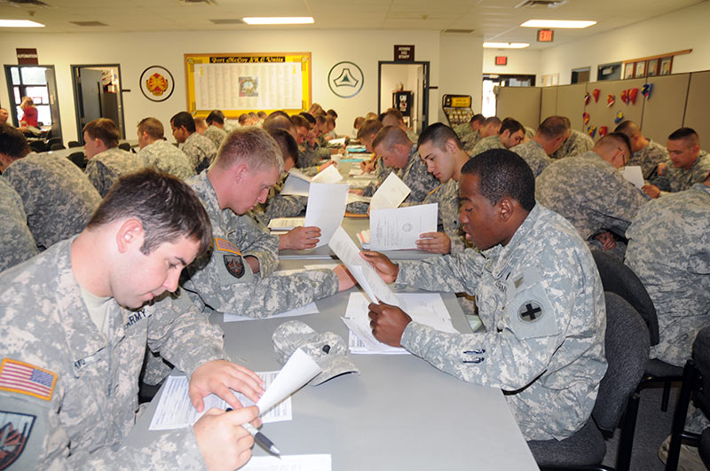 Soldiers complete paperwork in an office