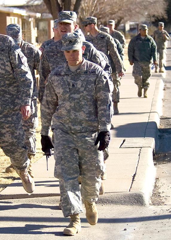 Soldiers walking on the sidewalk 