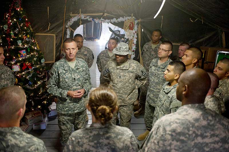 Soldier leading a discussion inside a tent