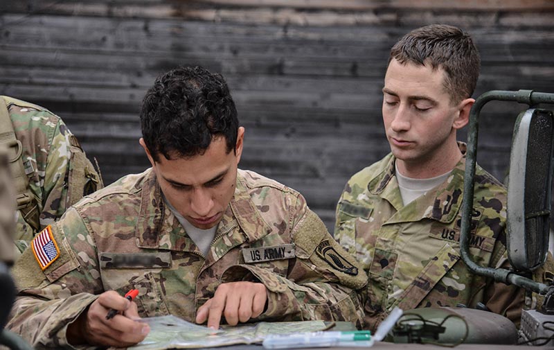 Soldiers work together to plot grid coordinates
