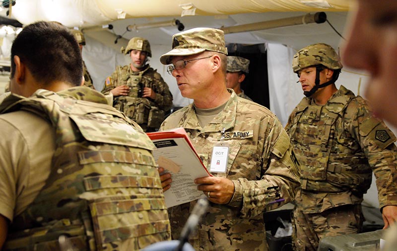 A trainer briefs medical personnel during a mission readiness exercise