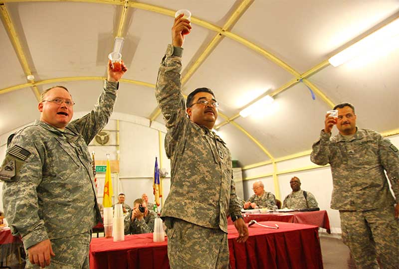 Three Soldiers raise their glasses