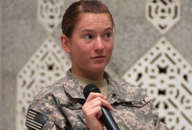 A private holds a microphone