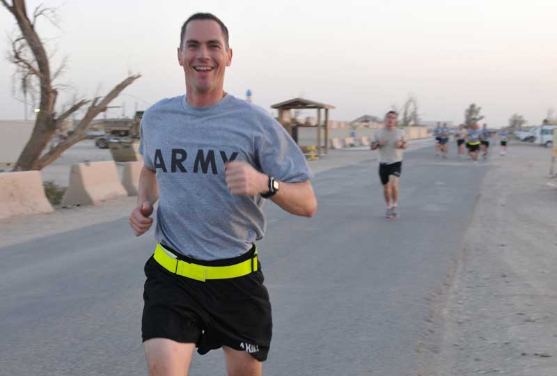 A Soldier smiles while running