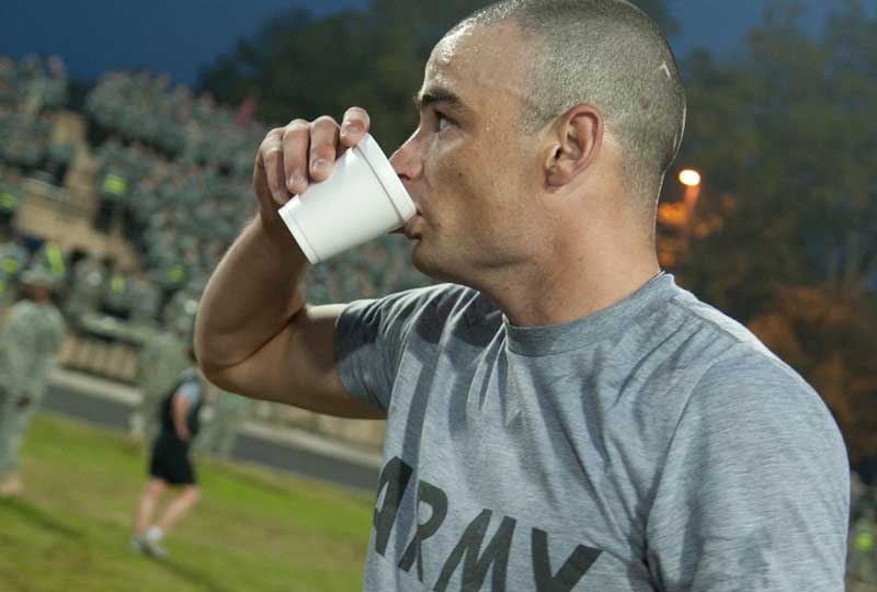 A Soldier drinks water after a soccer game