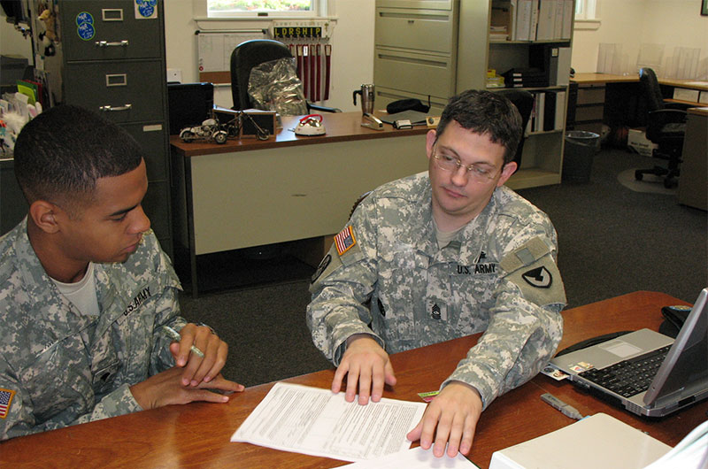 Two Soldiers looking over a document