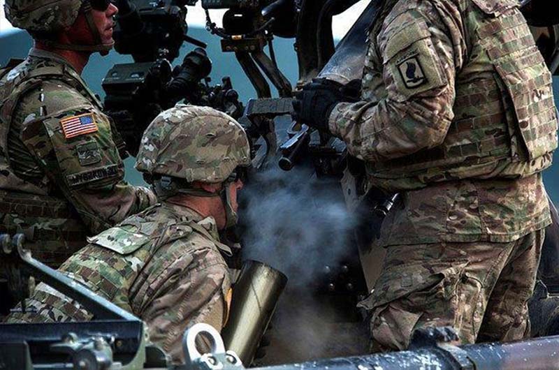 Soldiers firing a weapon