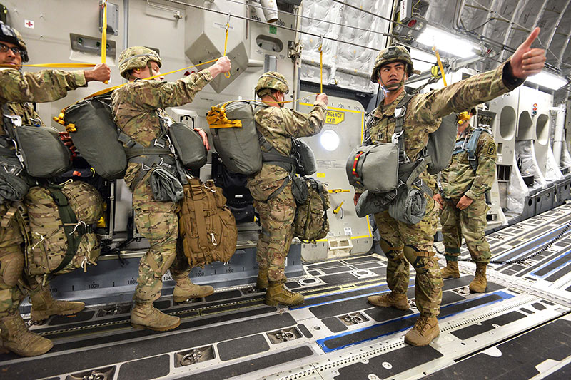 Army jumpmaster giving instructions to paratroopers