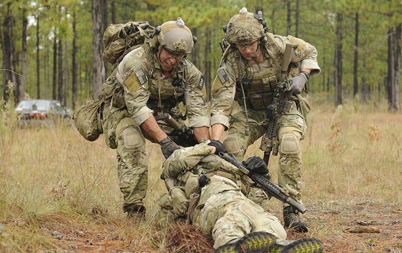 Soldiers react to a simulated improvised explosive device during a training event