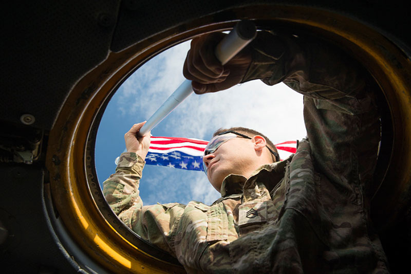 Soldier waving American flag