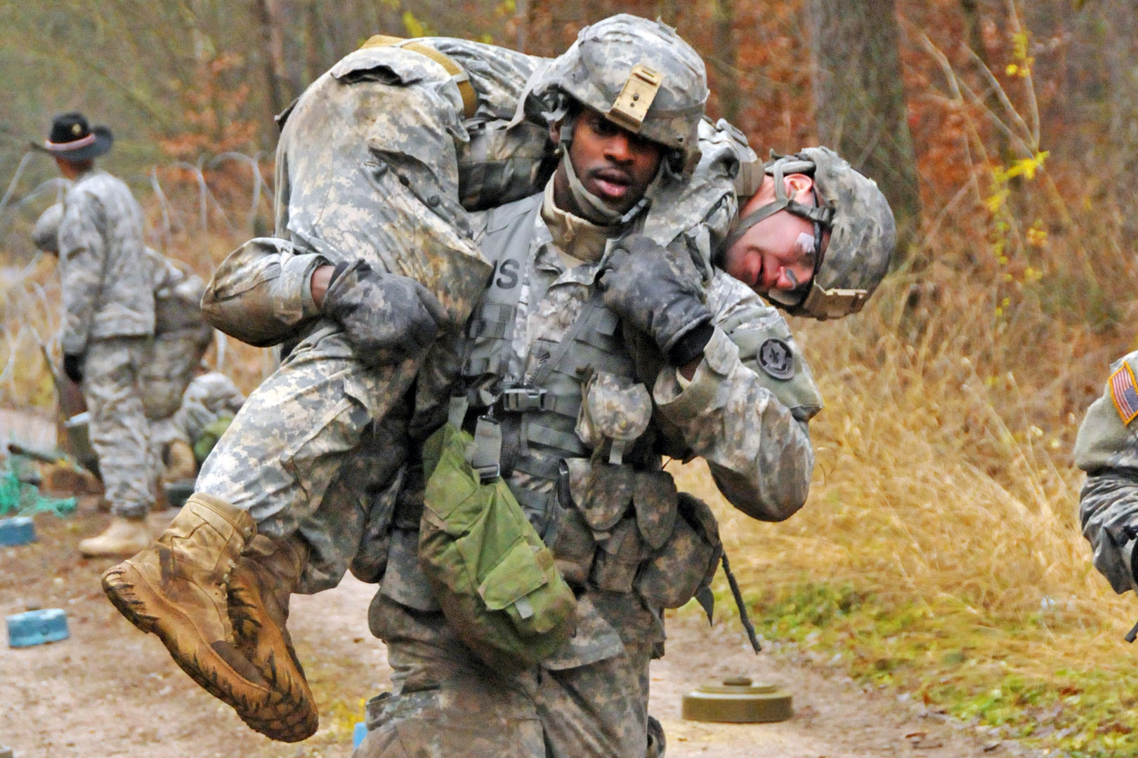 A Soldier carrying another Soldier on his back
