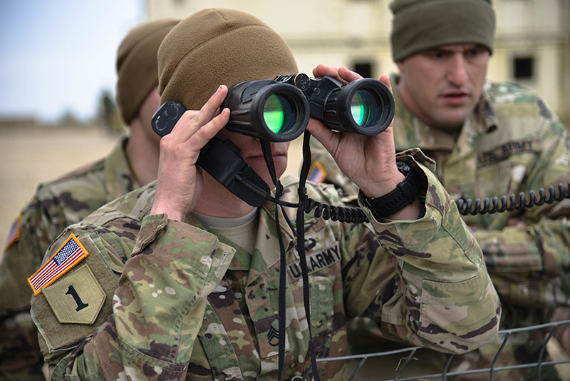 Soldier looking through binoculars