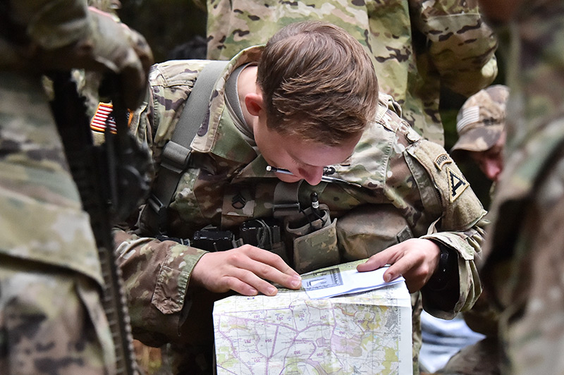: A Soldier looks at a map