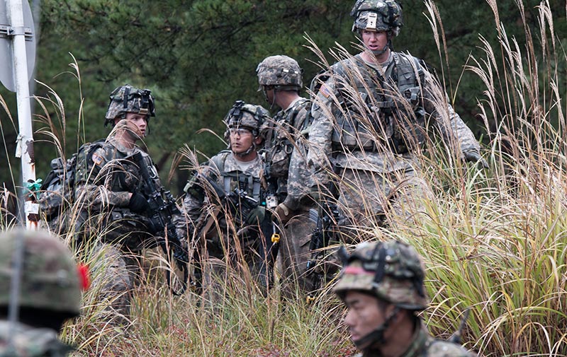 Soldiers talking amongst each other during an exercise