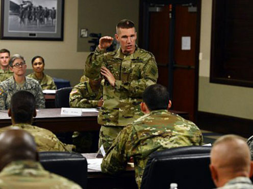 Commander speaking with a Soldier while shaking his hand