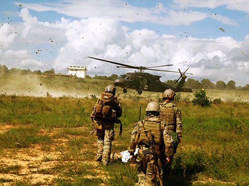 Commander speaking with a Soldier while shaking his hand