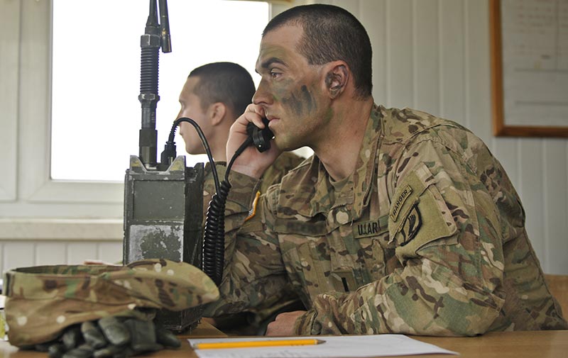 Soldier relays information to different teams during an exercise