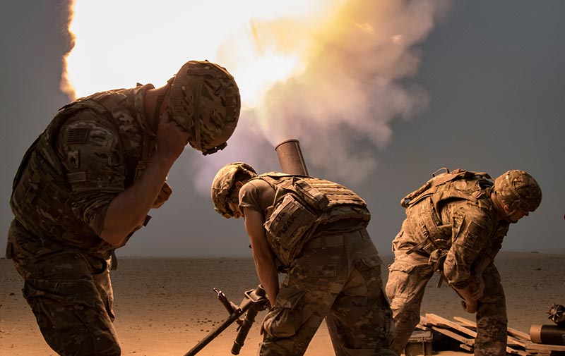 Soldiers fire a mortar round