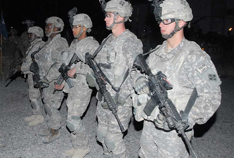 A team stands at attention with guns