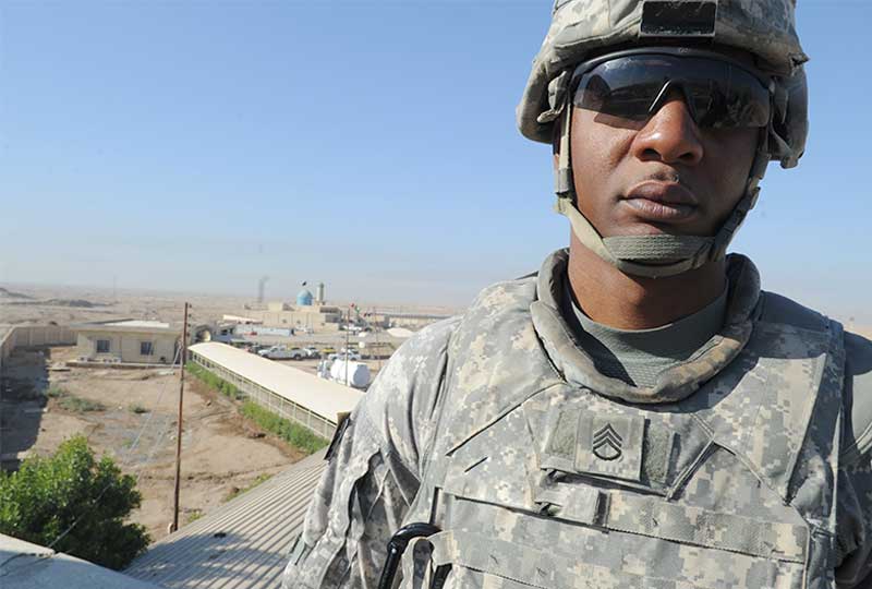 A staff sergeant stands on patrol
