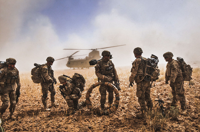 Soldiers gathering equipment before boarding a helicopter