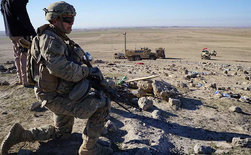 Soldier kneeling with weapon