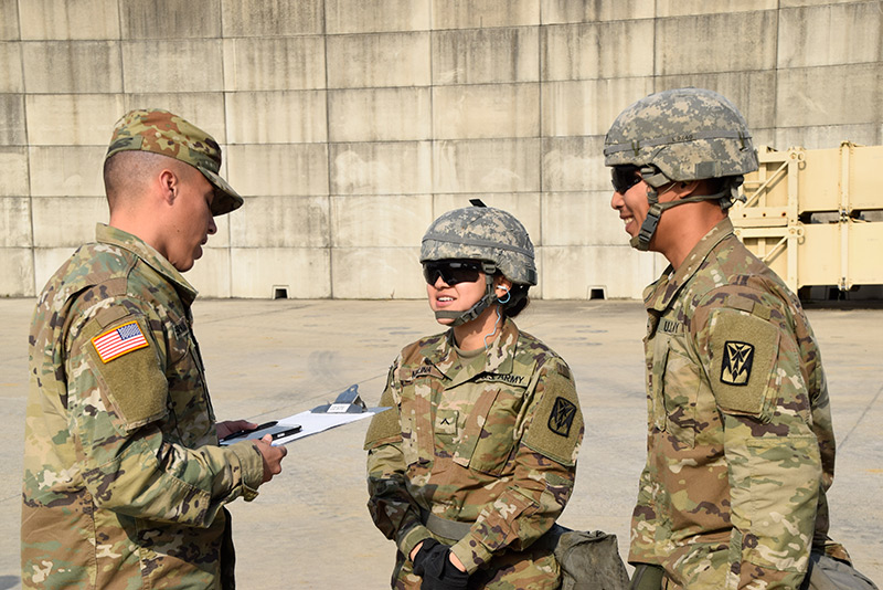 Three Soldiers talking to one another